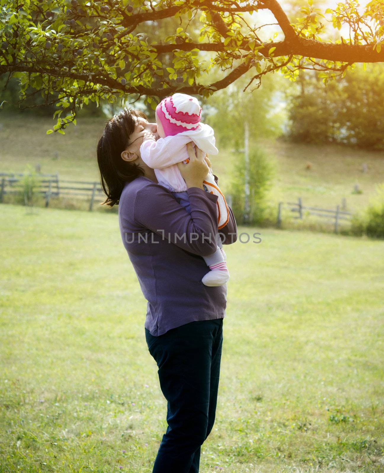 Happy Mother and baby outside playing