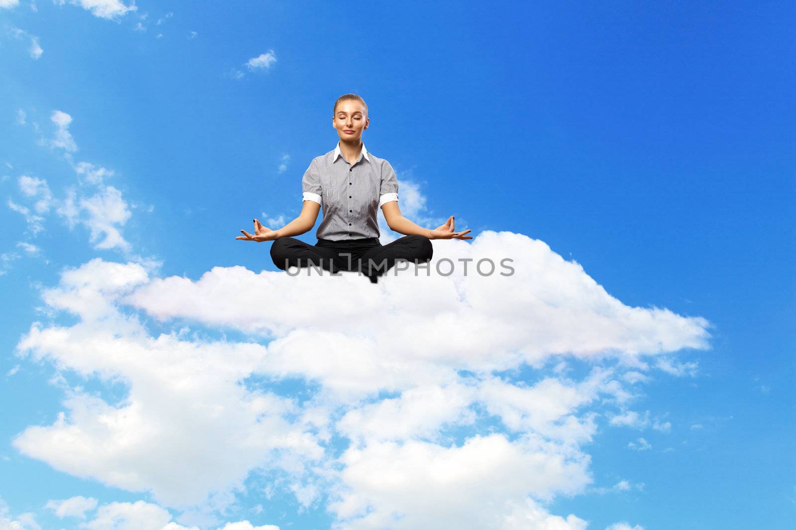 Businesswoman meditating sitting on the cloud by sergey_nivens