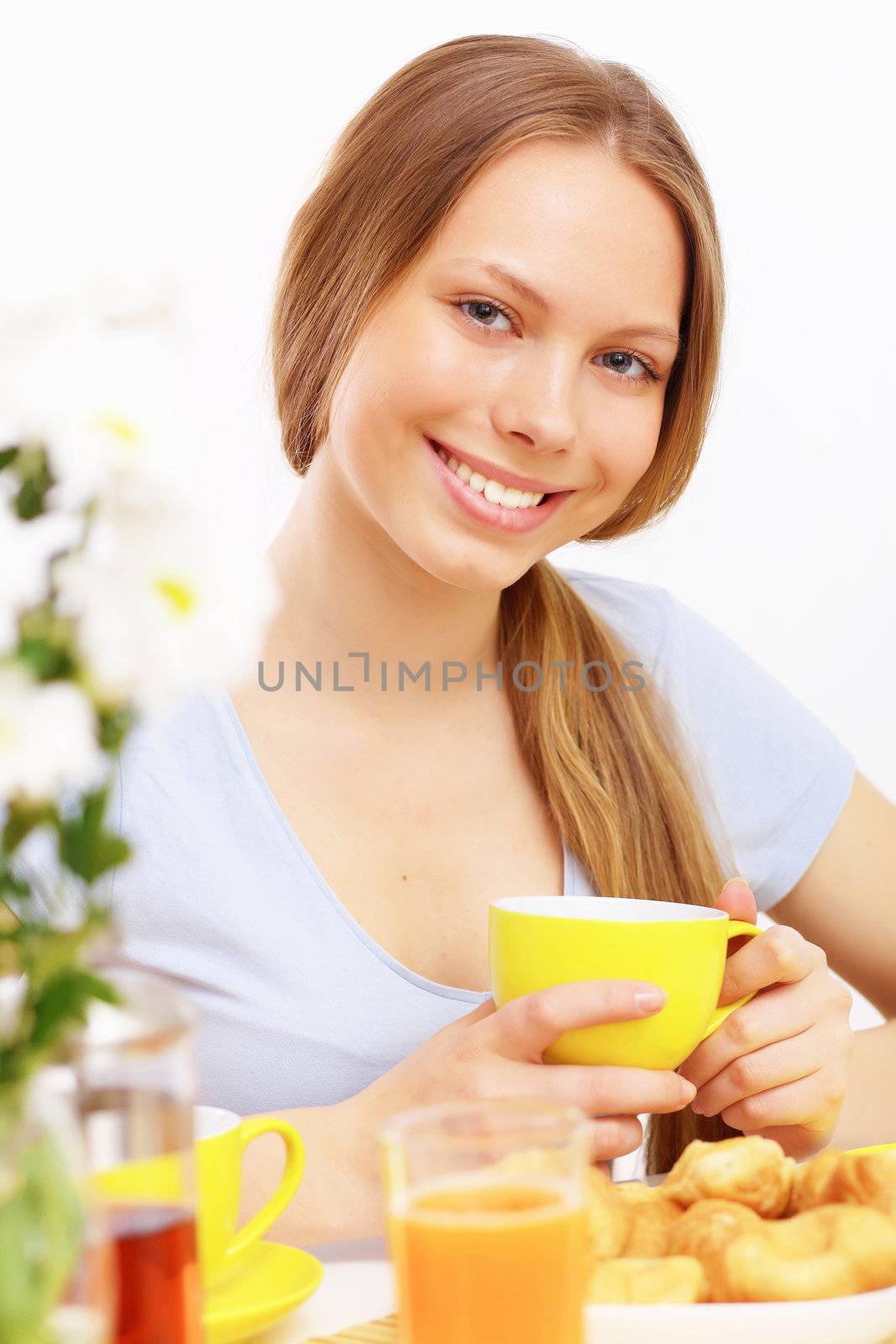 Beautiful young woman drinking tea by sergey_nivens