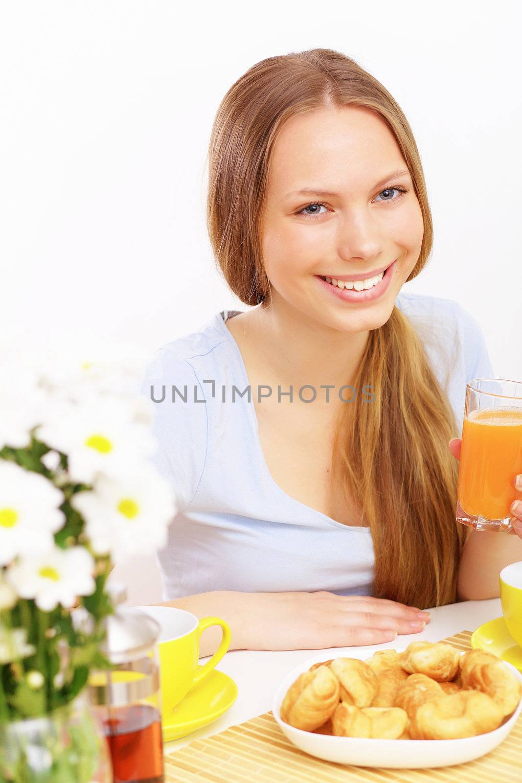 Beautiful young woman drinking tea from yellow cup