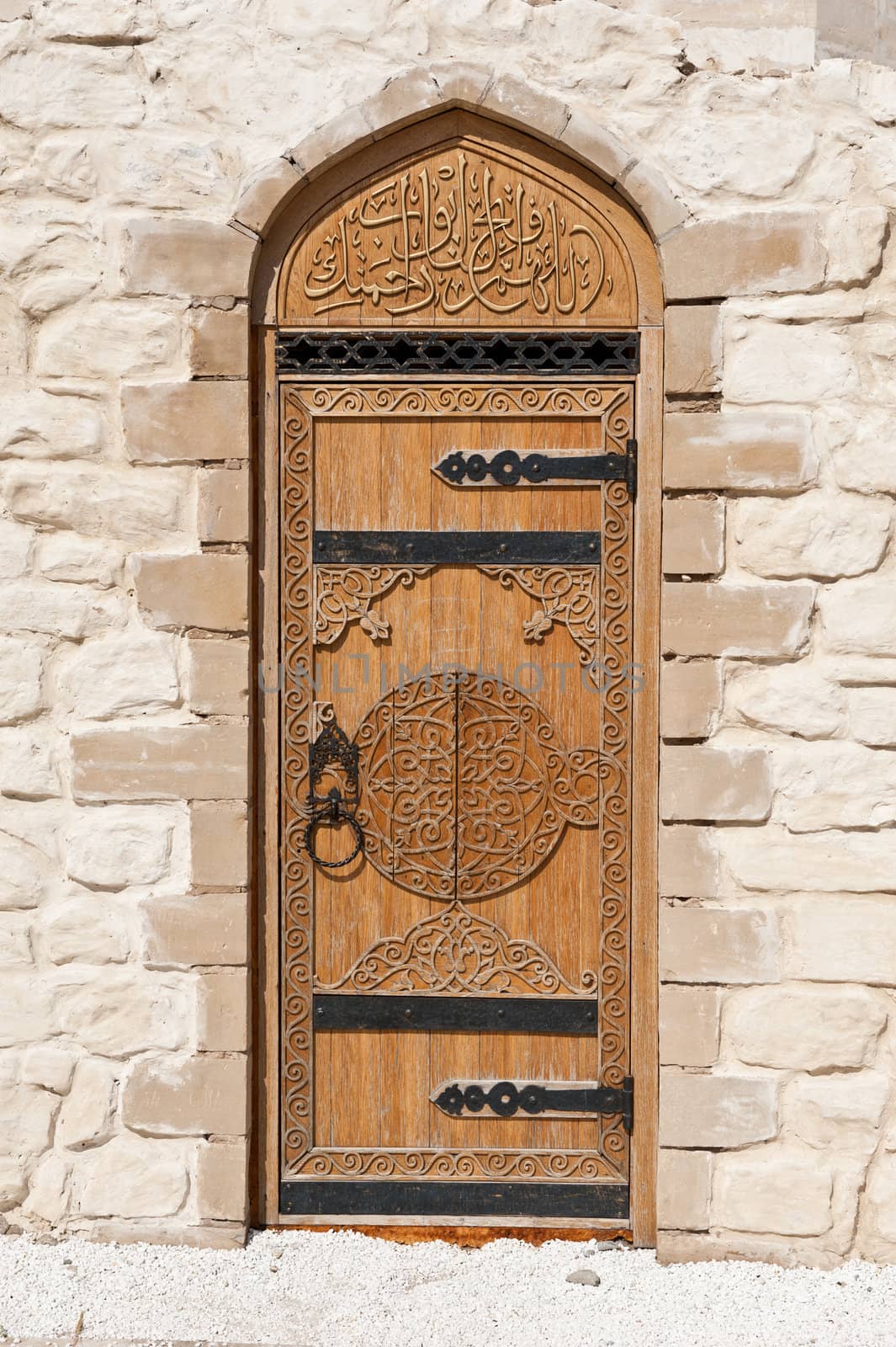 door with Arabic script in the stone wall
