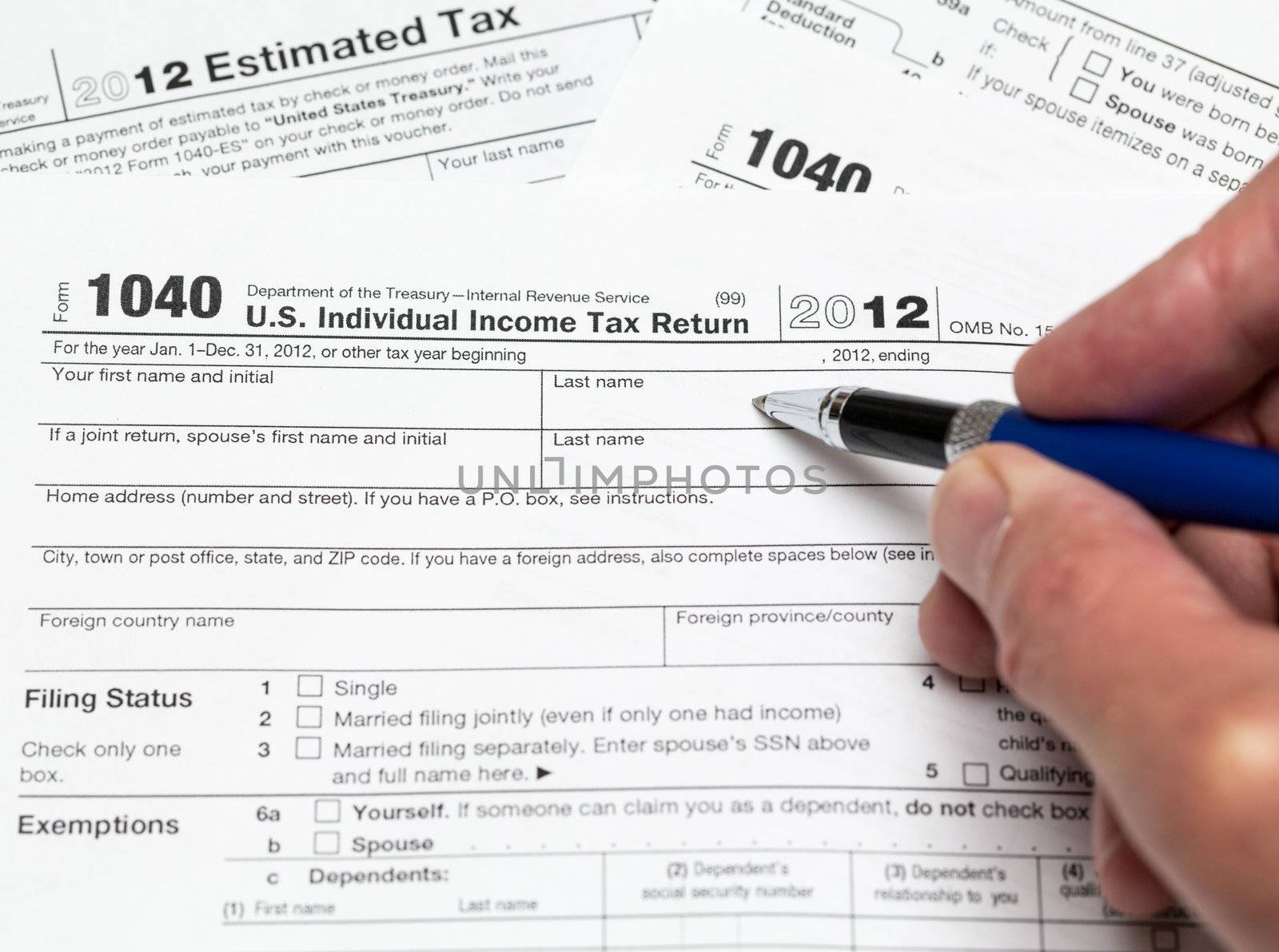 Tax form 1040 for tax year 2012 for US individual tax return with hand
