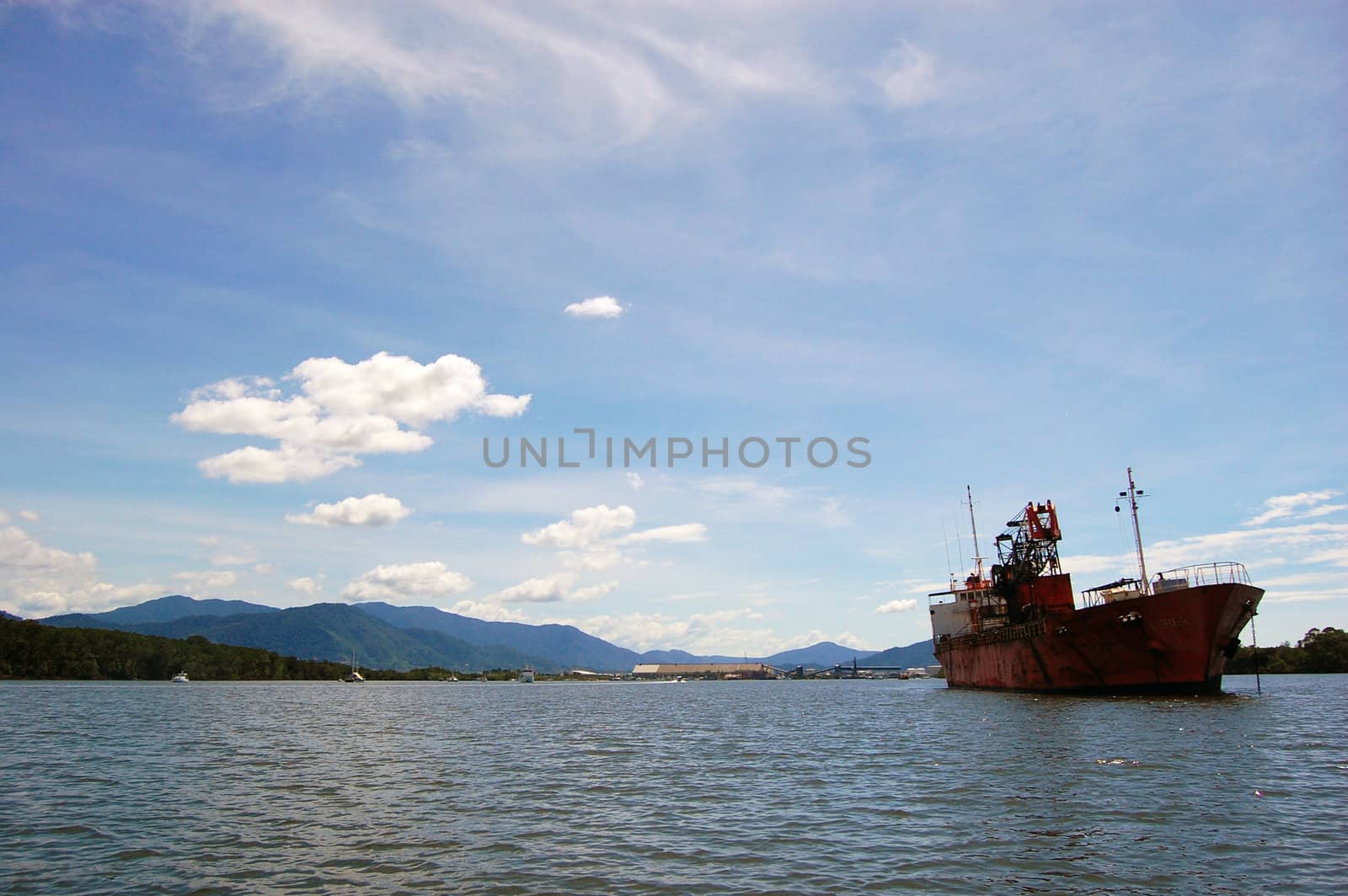 Abandoned red ship on the river nearby Cairns, Australia