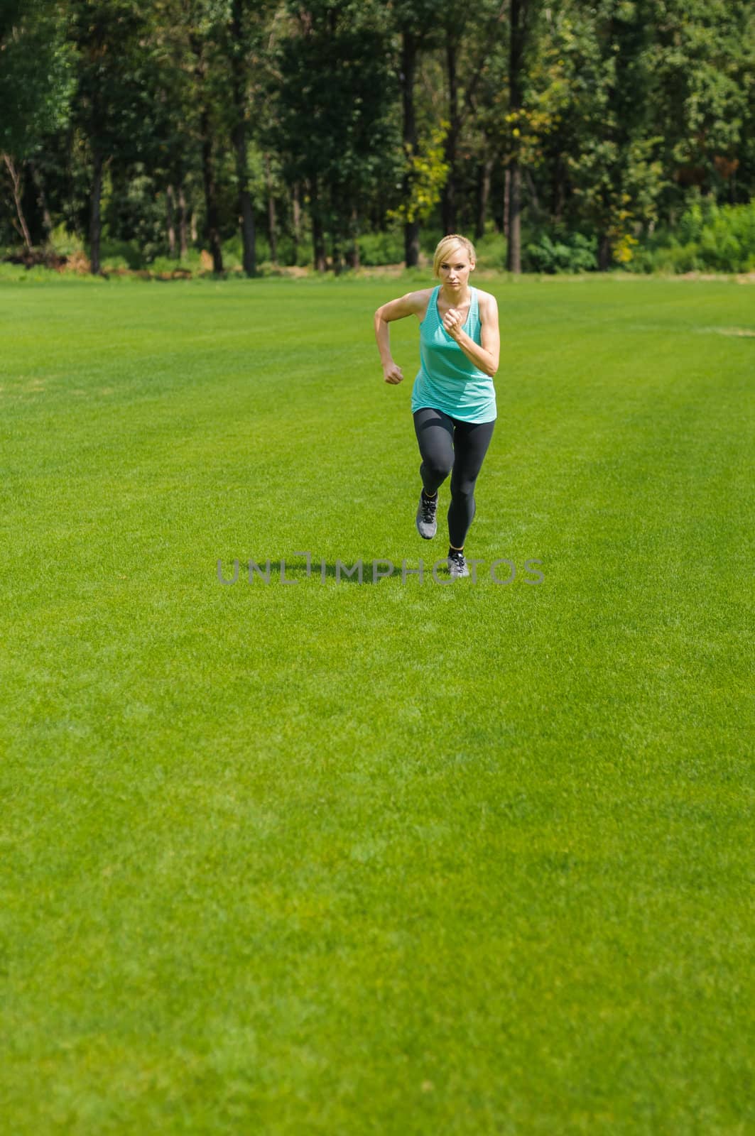 An active beautiful caucasian woman running outdoor in a park