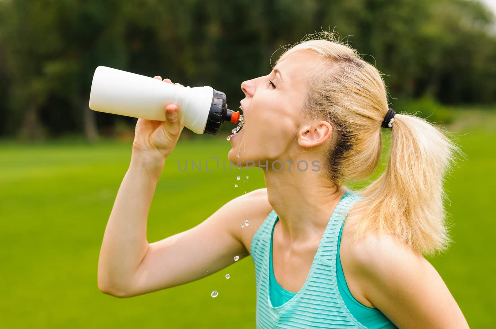 Young girl drinking water by nvelichko