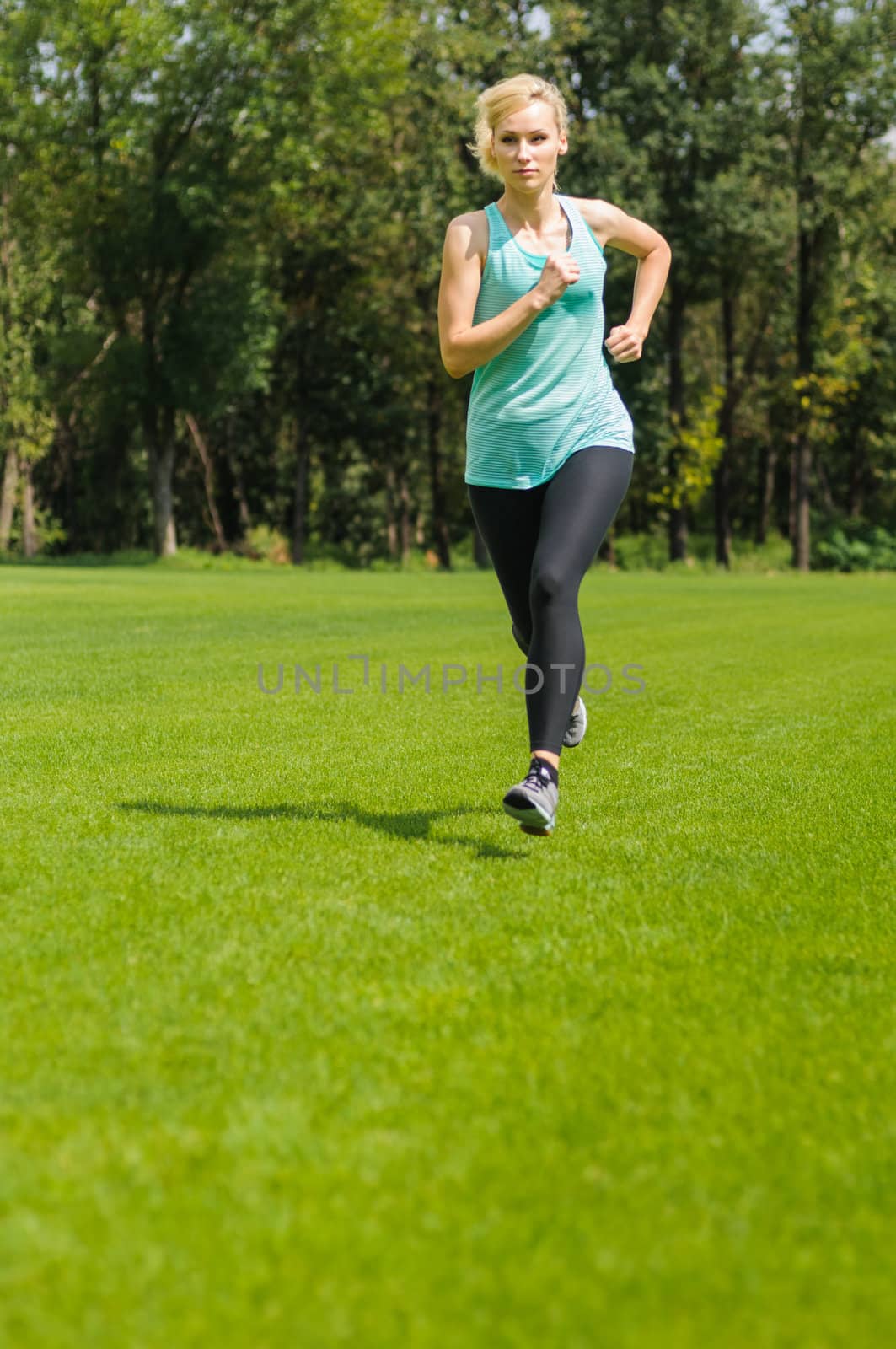 Portrait of a young woman jogging by nvelichko