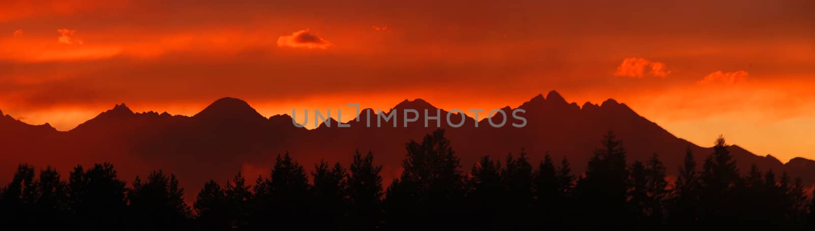 Panoramic photo of Tatras mountains in Slovakia after the storm in the evening at dusk