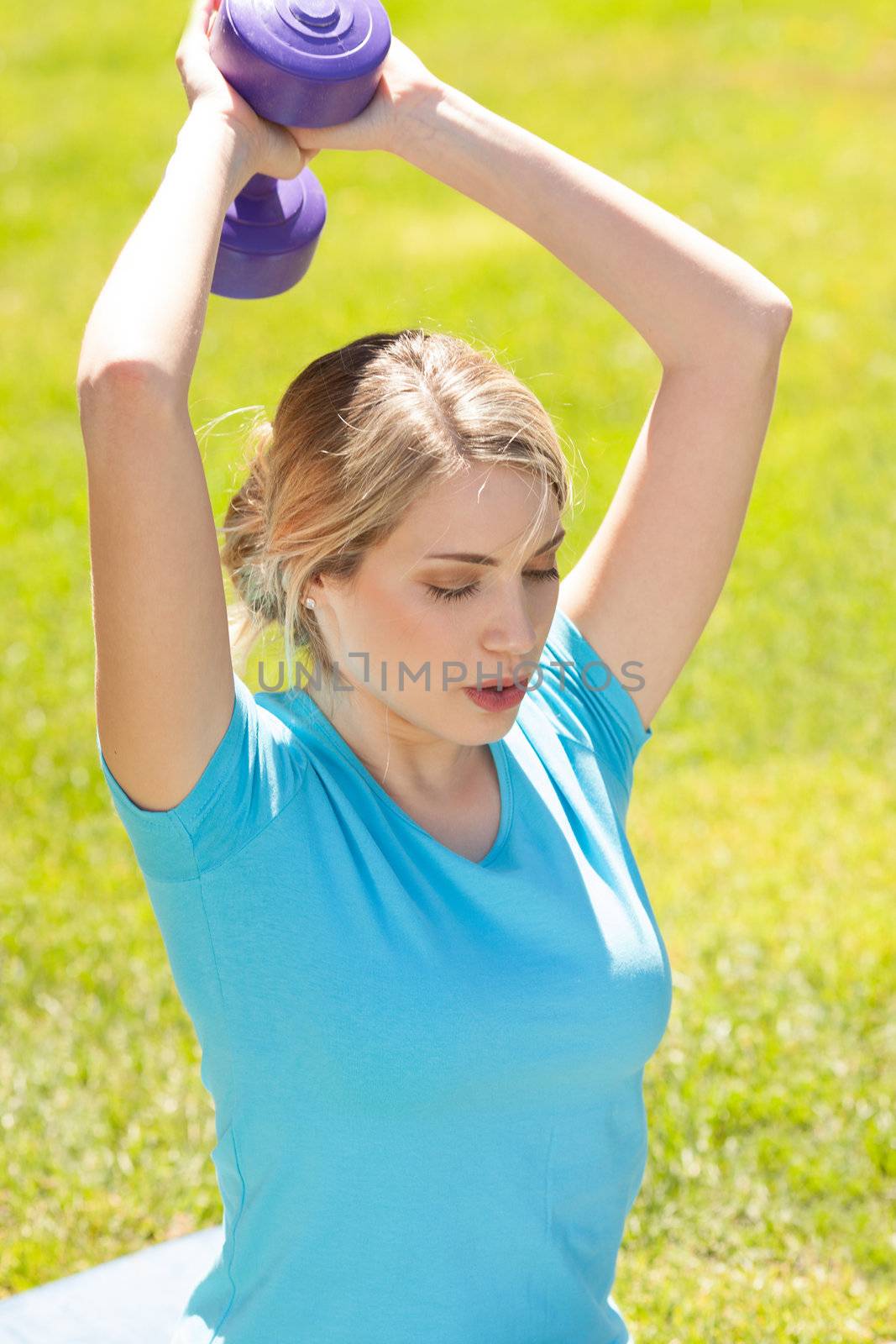 Young sport woman lift weight work out outdoors