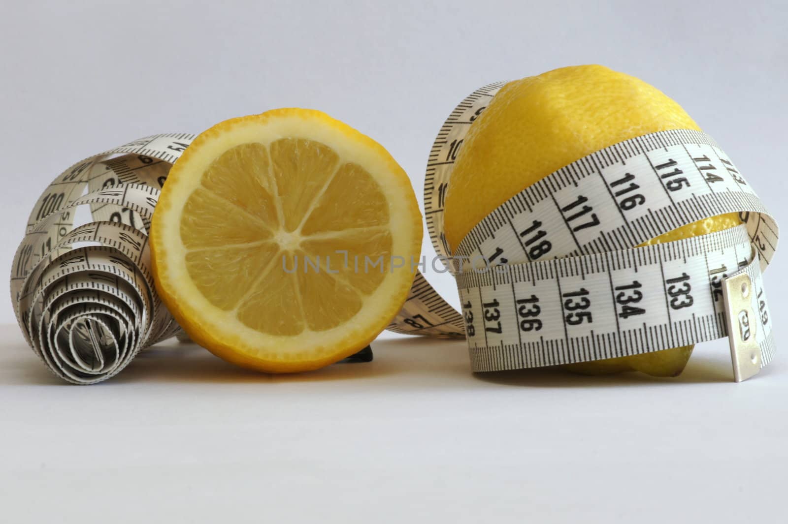 Close-up of a lemon with a measuring tape around it