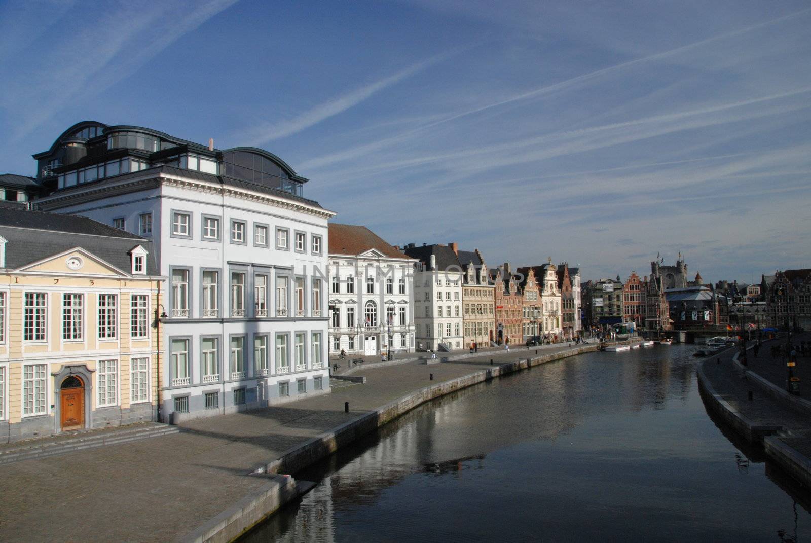 gabled houses along a canal in Gent, Belgium with reflection on the water 