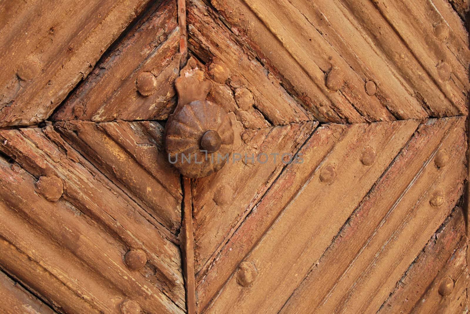 Detail of the old door with orange cracked paint