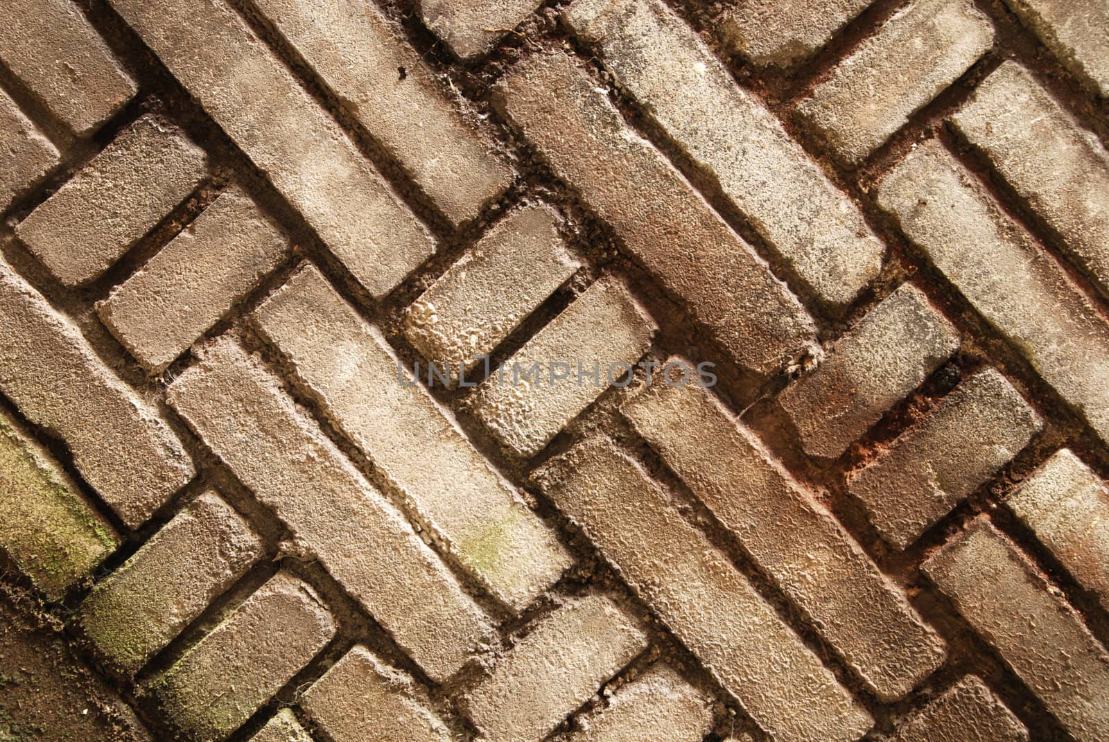 An old wall background with cracked paint and broken bricks