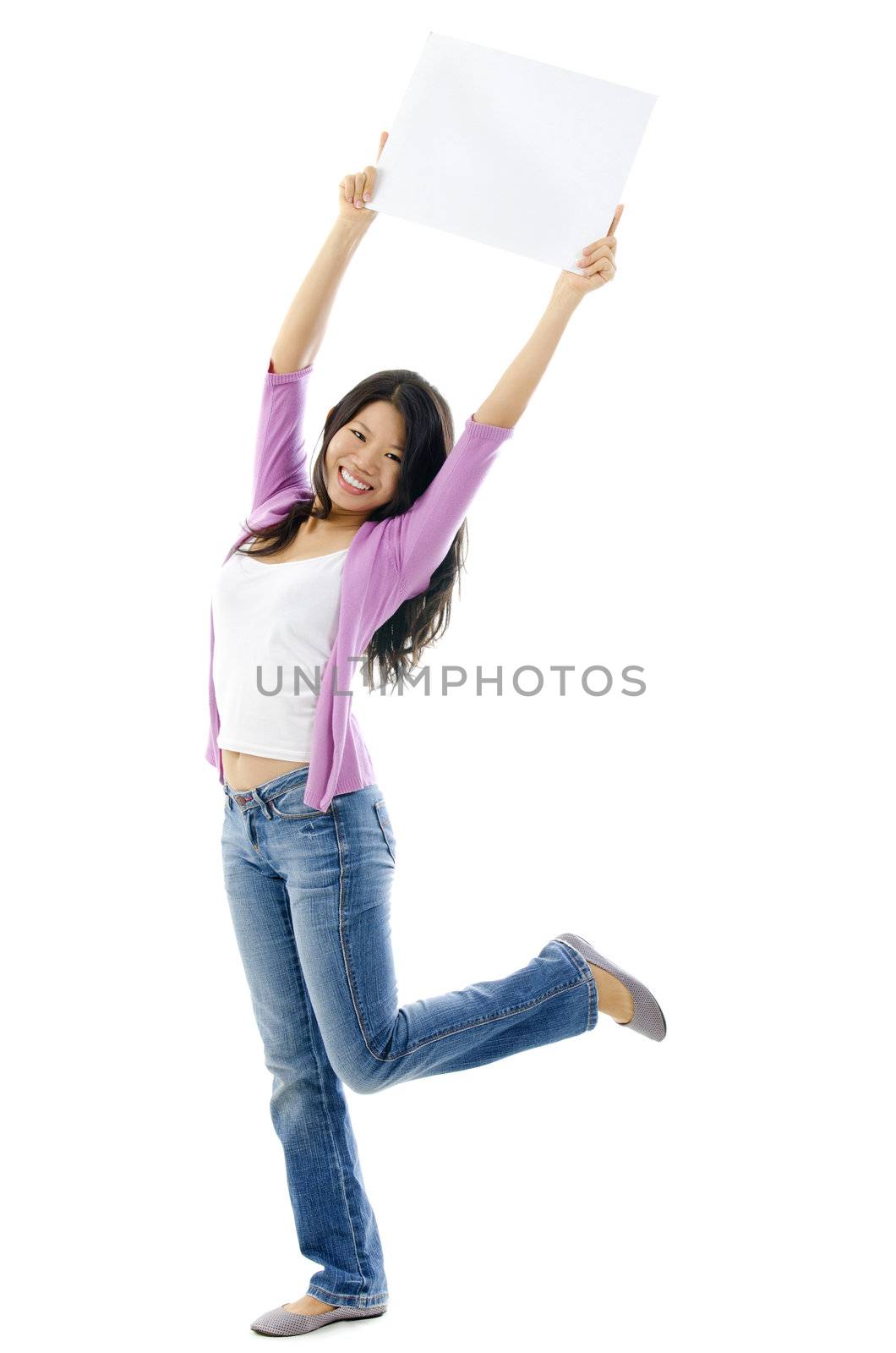 Happy Asian woman holding blank sign above her head. Full length on white background.