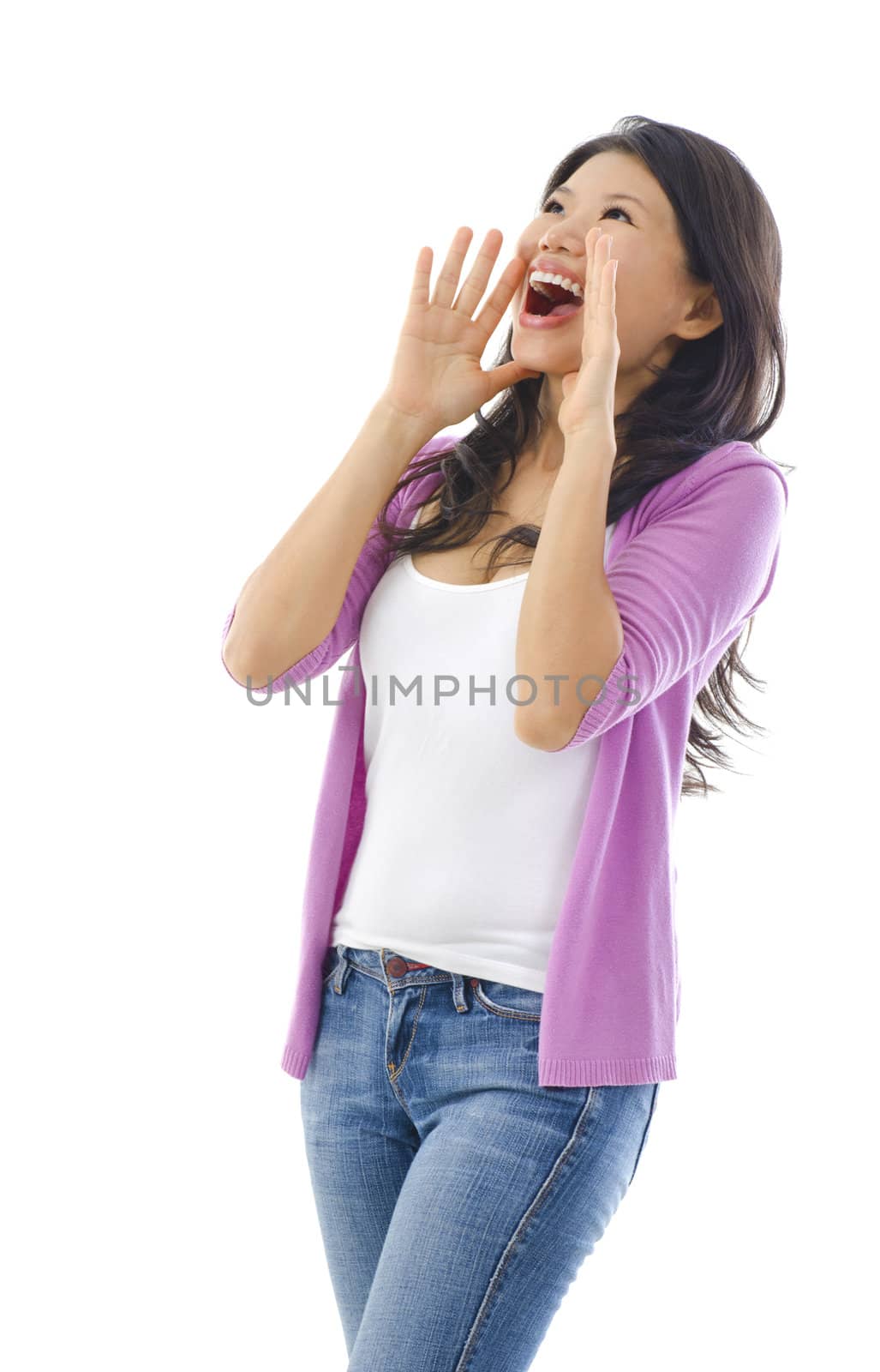 Asian female holding hands beside her cheeks and shouts an announcement.