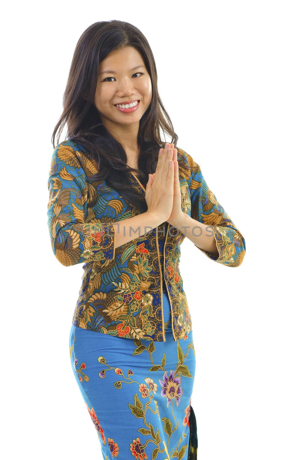 Southern Thai woman in a traditional welcoming gesture over white background