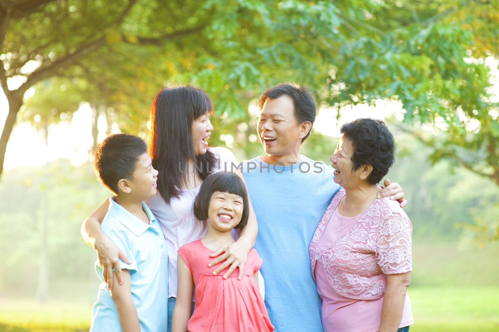 Happy Asian family having conversation at outdoor