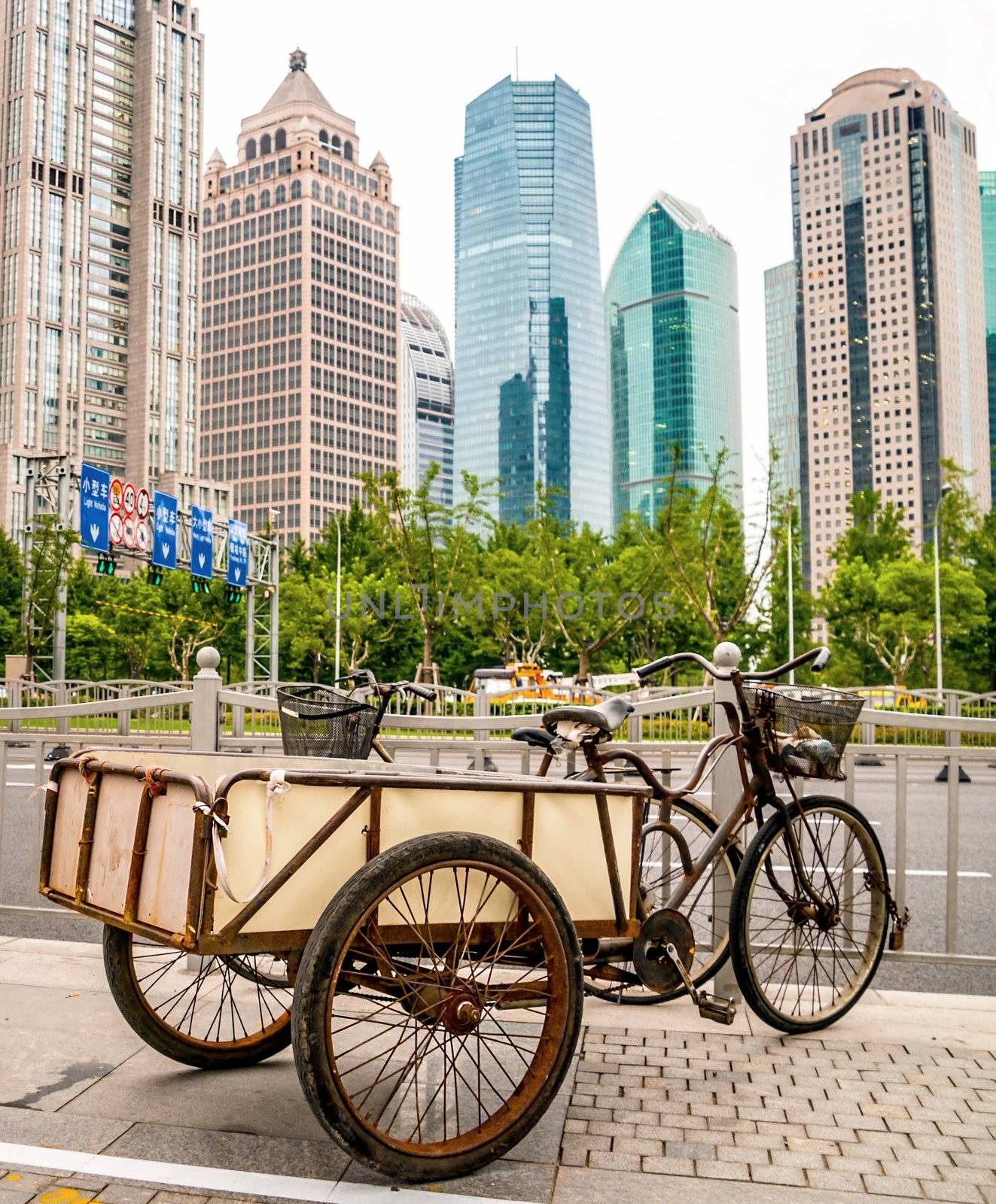 Old rusty vehicle in Jakarta business disctrict with skyscrapers in background