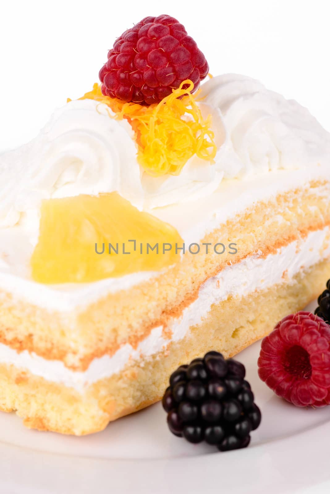 Tasty cake with cream and raspberries isolated on white.