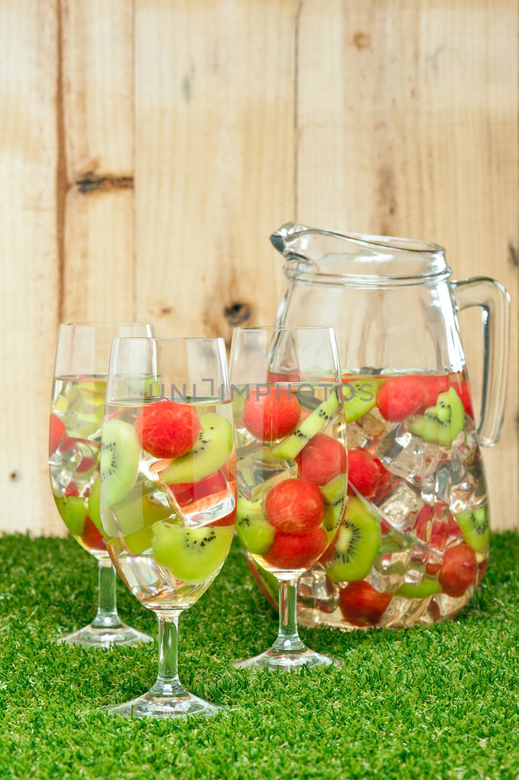 Kiwi Melon Sangria in front of timber wall