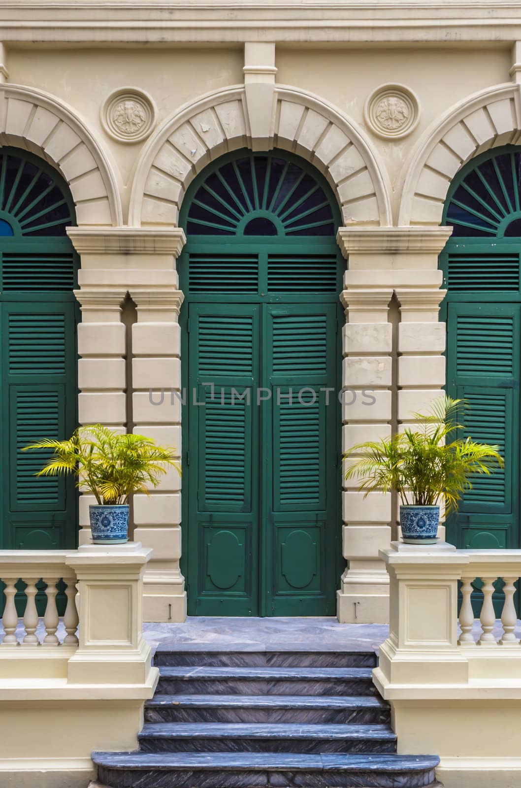 European style green door of old building in Grand Palace ,Bangkok Thailand. This photo is taken at the tourist's exit of Grand Palace.
