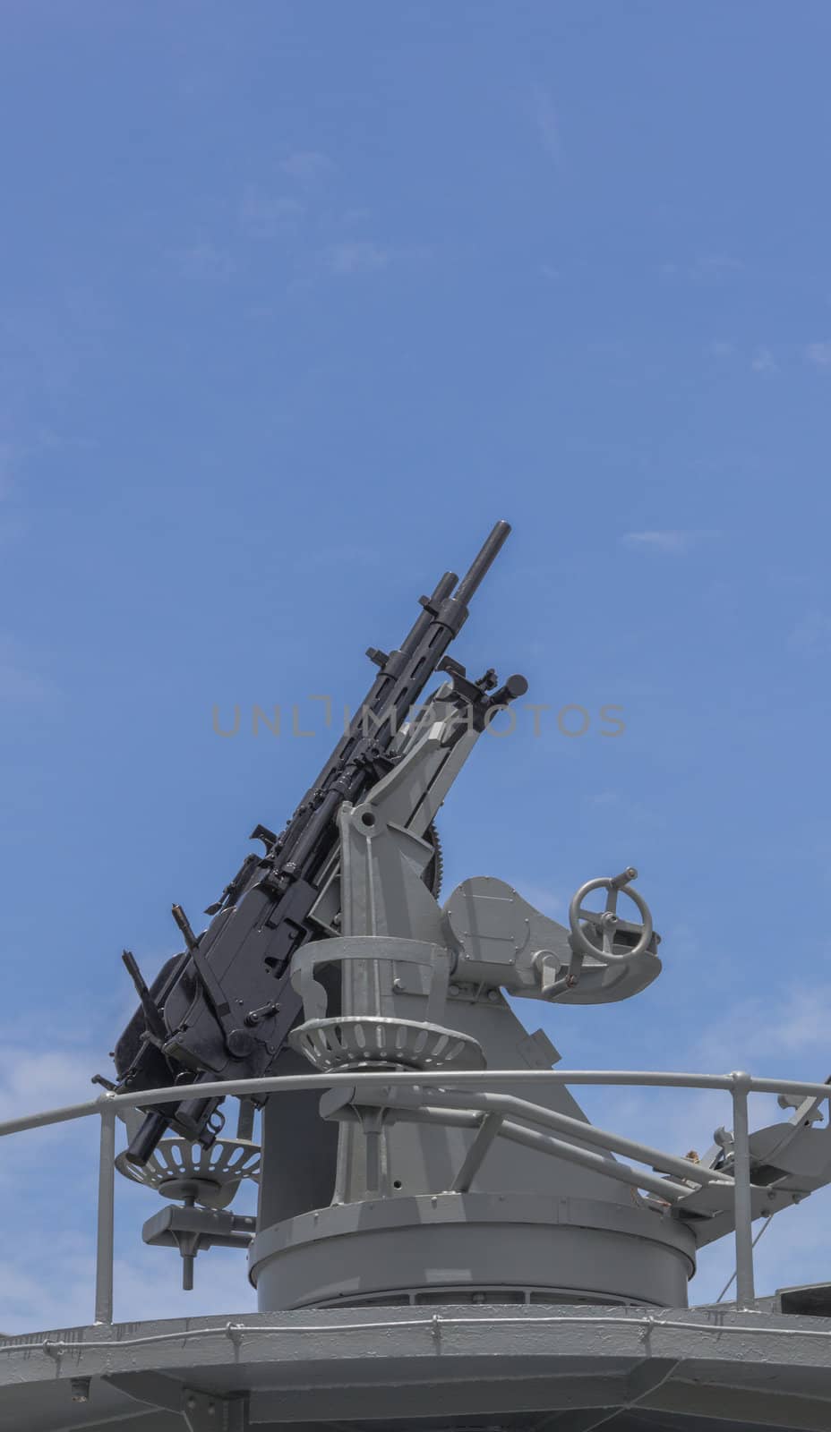 Machine gun on the deck of battleship with the blue sky background