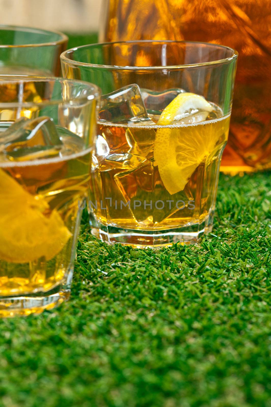 Iced Lemon Ice Tea in on a lawn in summer 