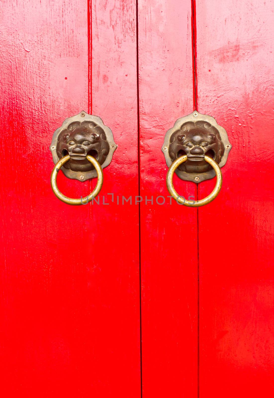 Red chinese door with a lion/dragon head.