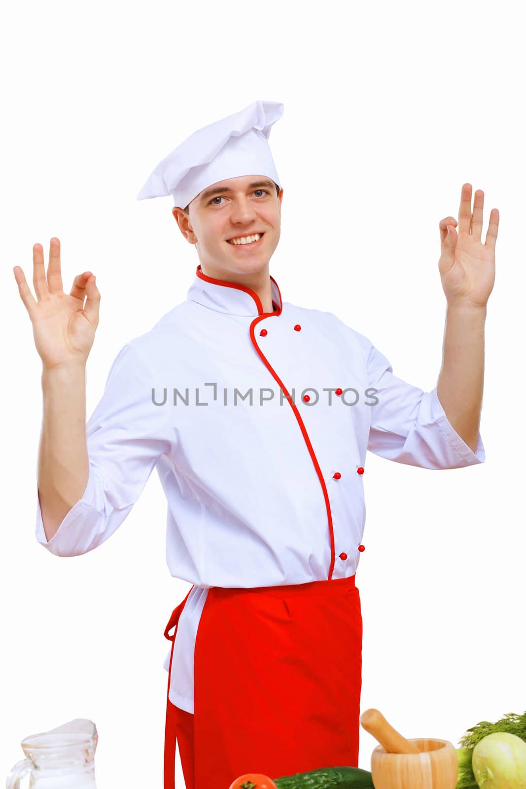 Young cook preparing food wearing a red apron