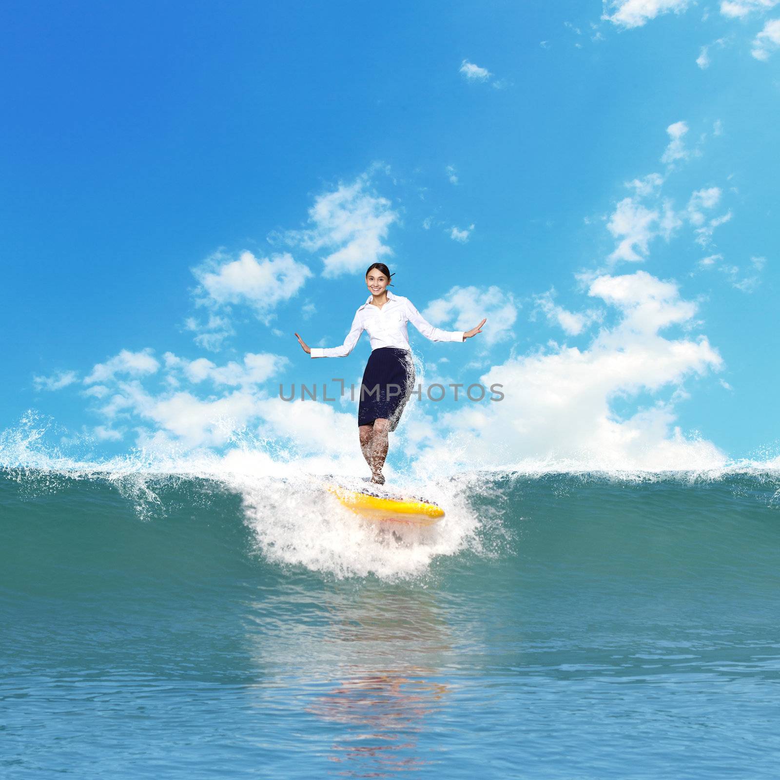 Image of young business person surfing on the waves of the ocean