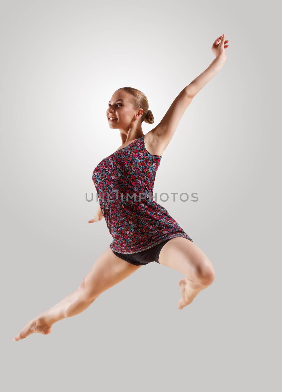 Girl dancing in a color dress with a gray background. isolate