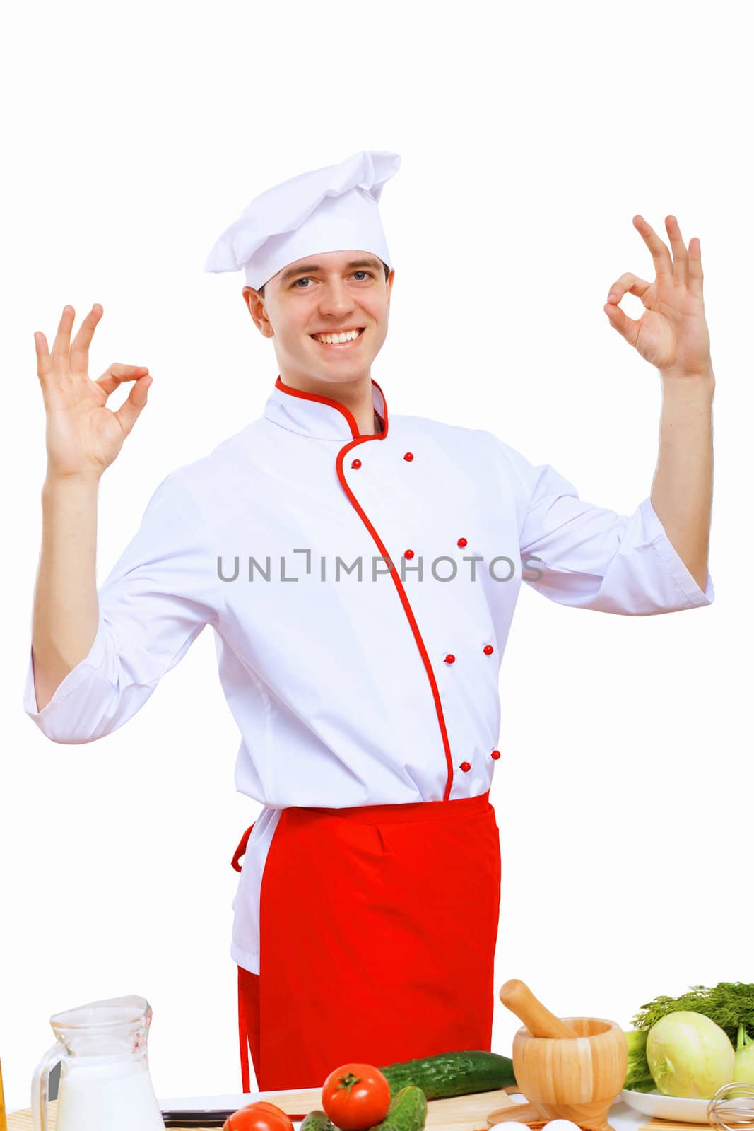 Young cook preparing food wearing a red apron