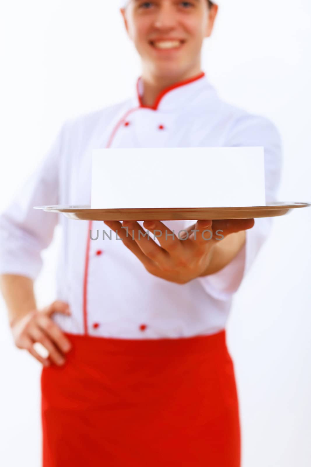 Male cook in uniform holding an empty tray