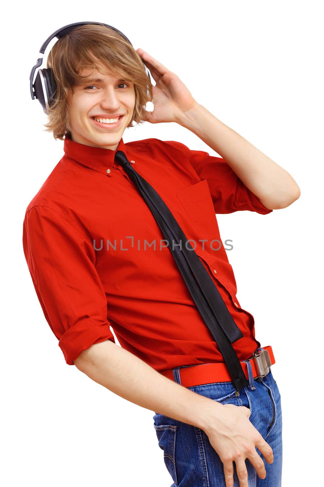 Happy smiling young man dancing and listening to music