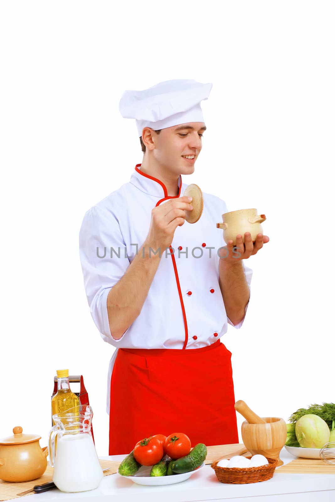 Young cook preparing food wearing a red apron