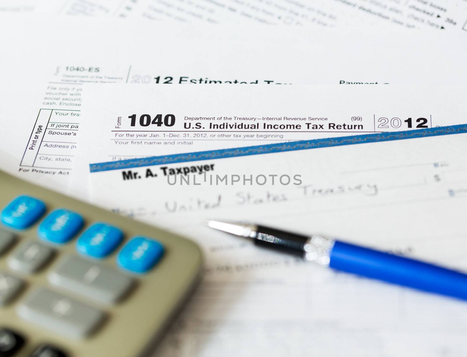 Tax form 1040 for tax year 2012 for US individual tax return with pen and check