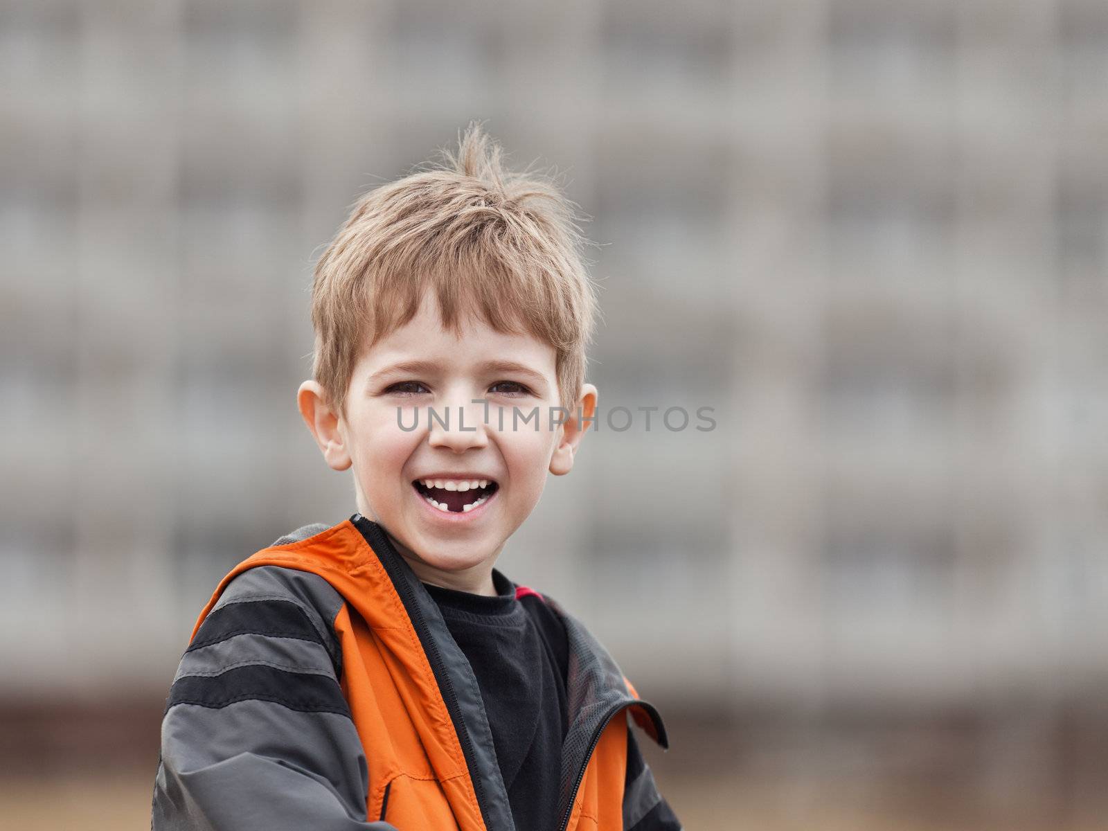Little cheerful child boy walking outdoor and smiling for happiness and fun