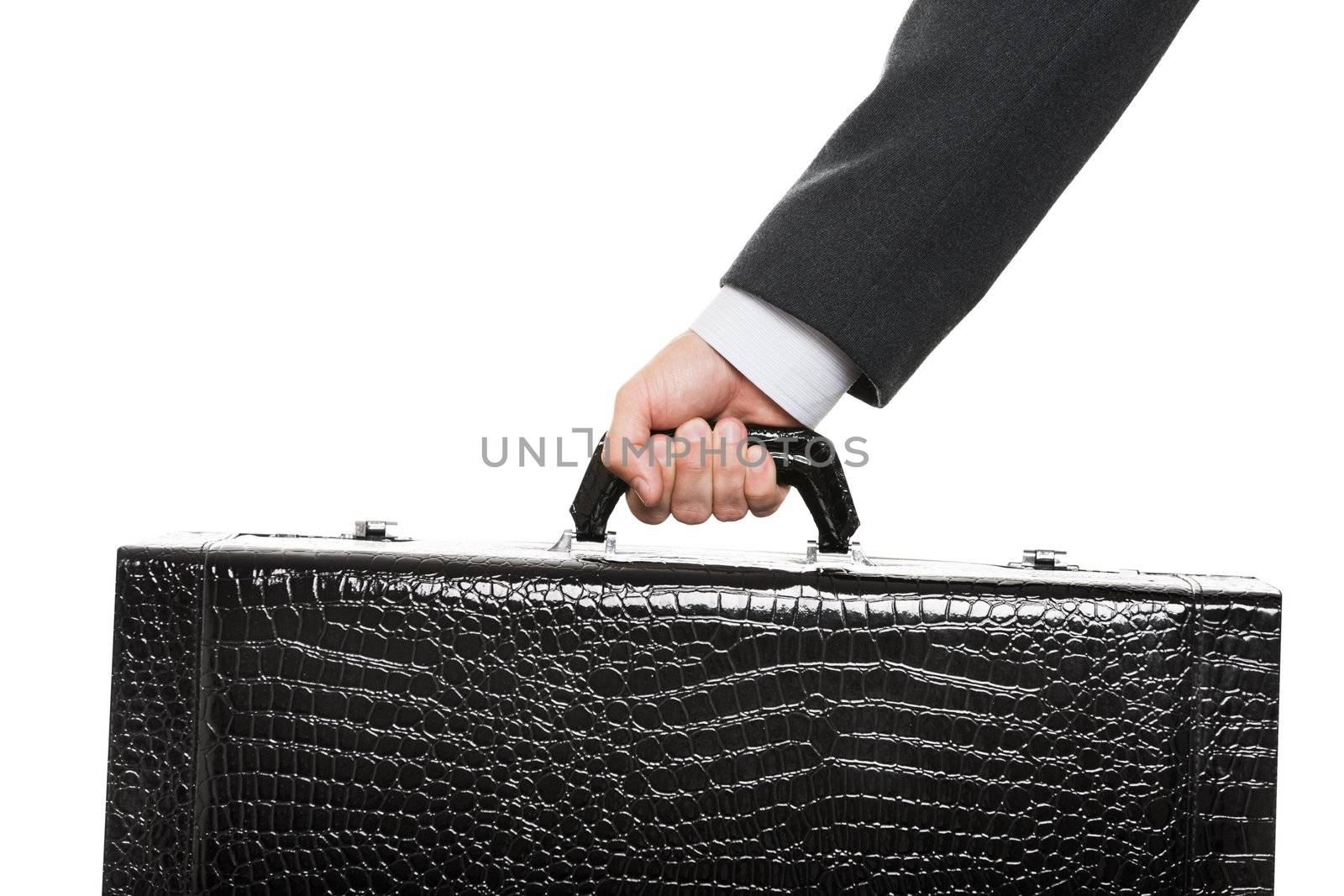 Business man in black suit hand holding large travel luggage suitcase