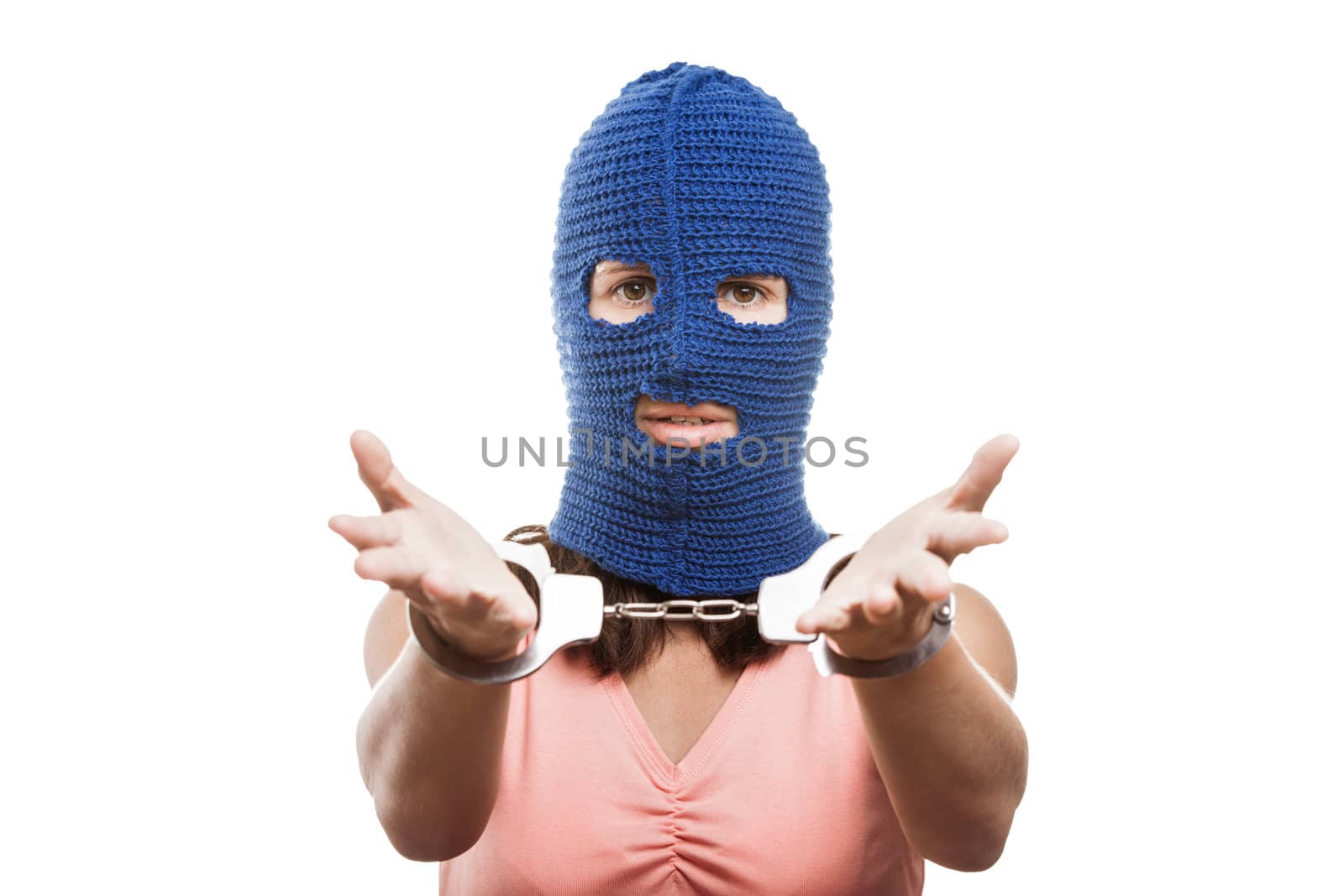 Woman in balaclava showing handcuffs on hands by ia_64