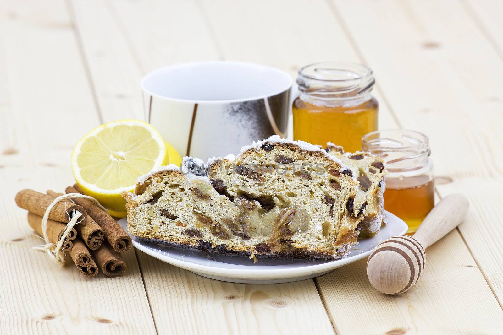 christmas stollen, honey, lemon and cinnamon sticks