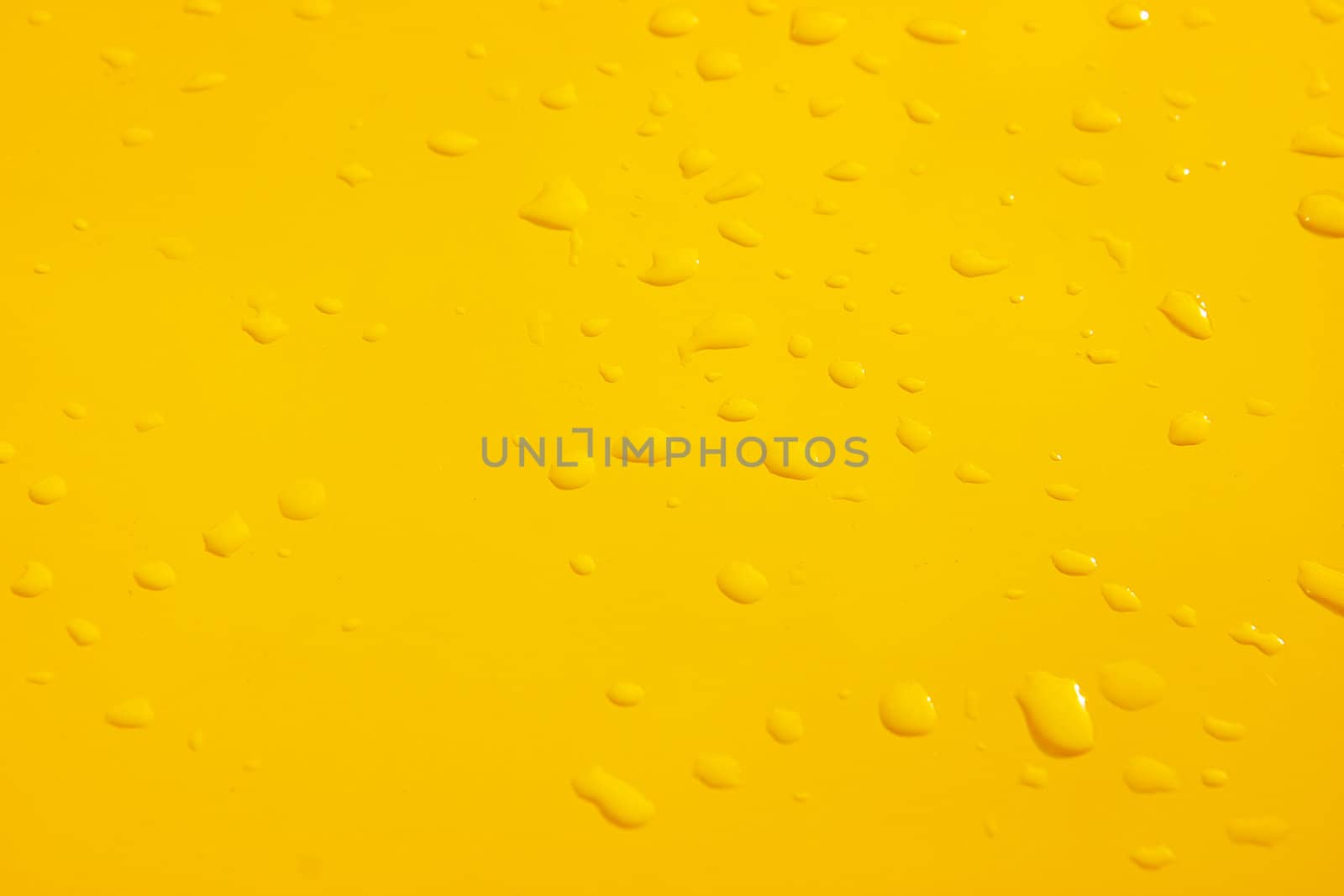 raindrops on the surface painted in yellow metal