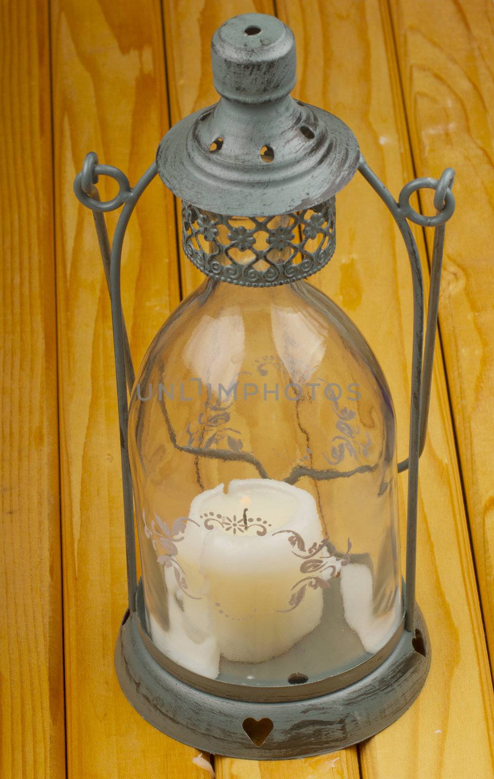 Old metal lantern over a wooden background