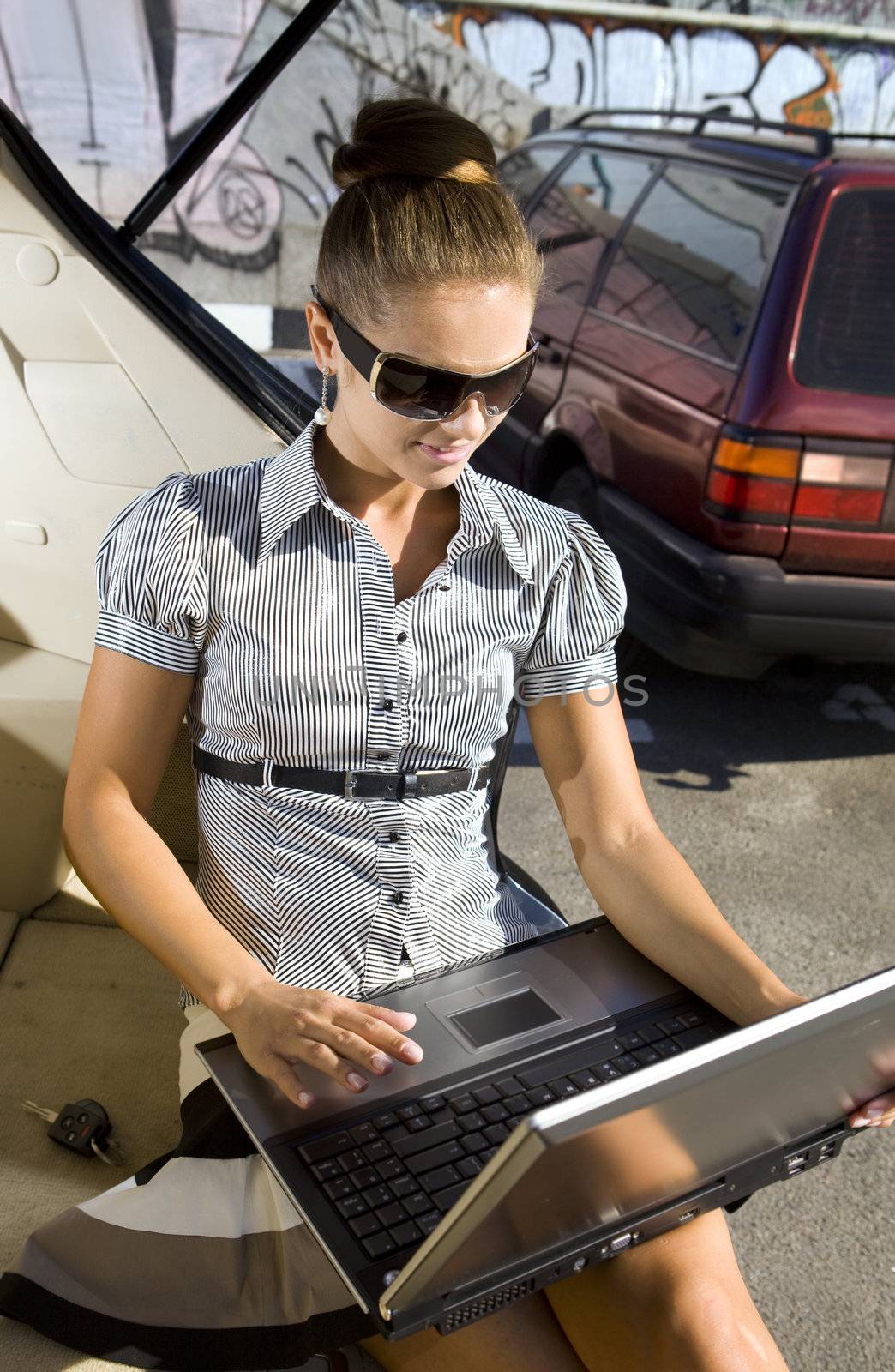 woman has a fan with laptop by ssuaphoto