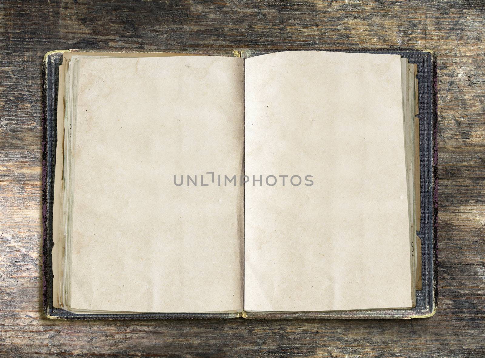 Vintage book, open, on old wooden table, with clipping path