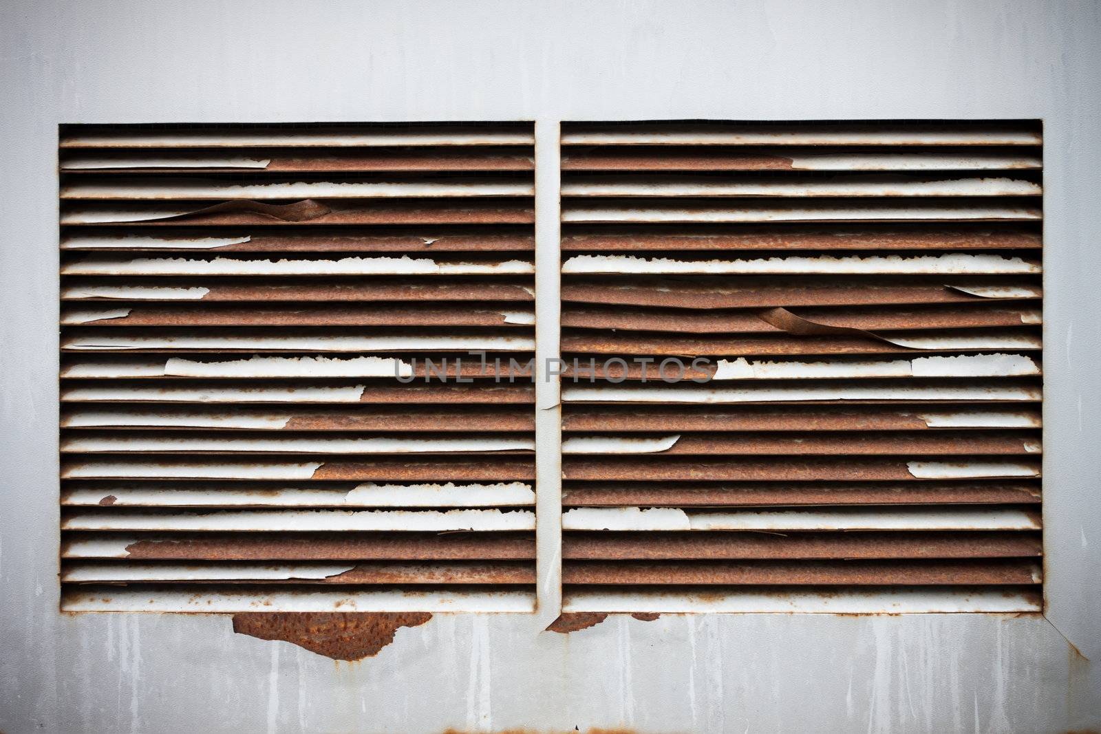 Old metal rusty ventilation windows on wall background