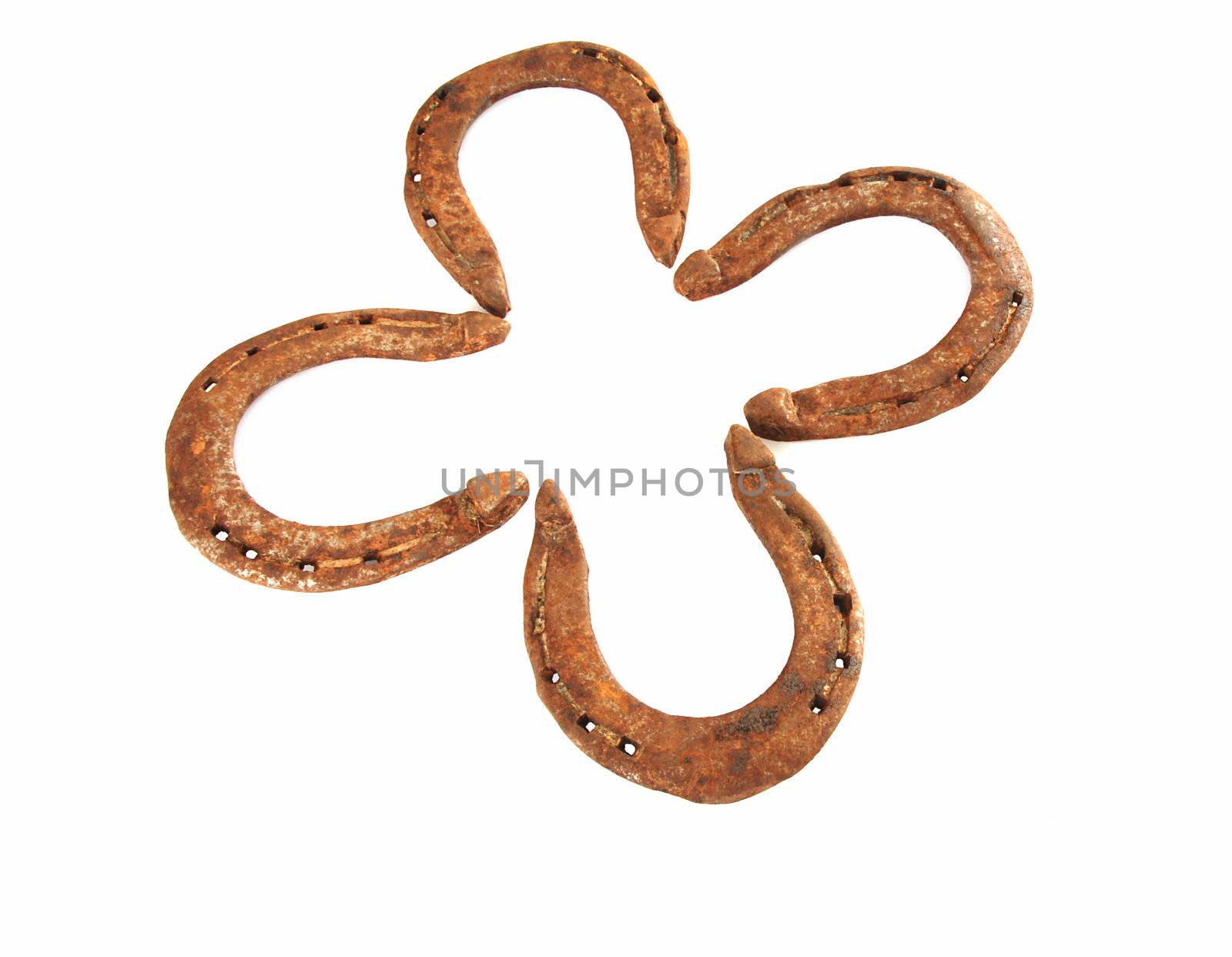Four horseshoes create lucky four leaves clover 