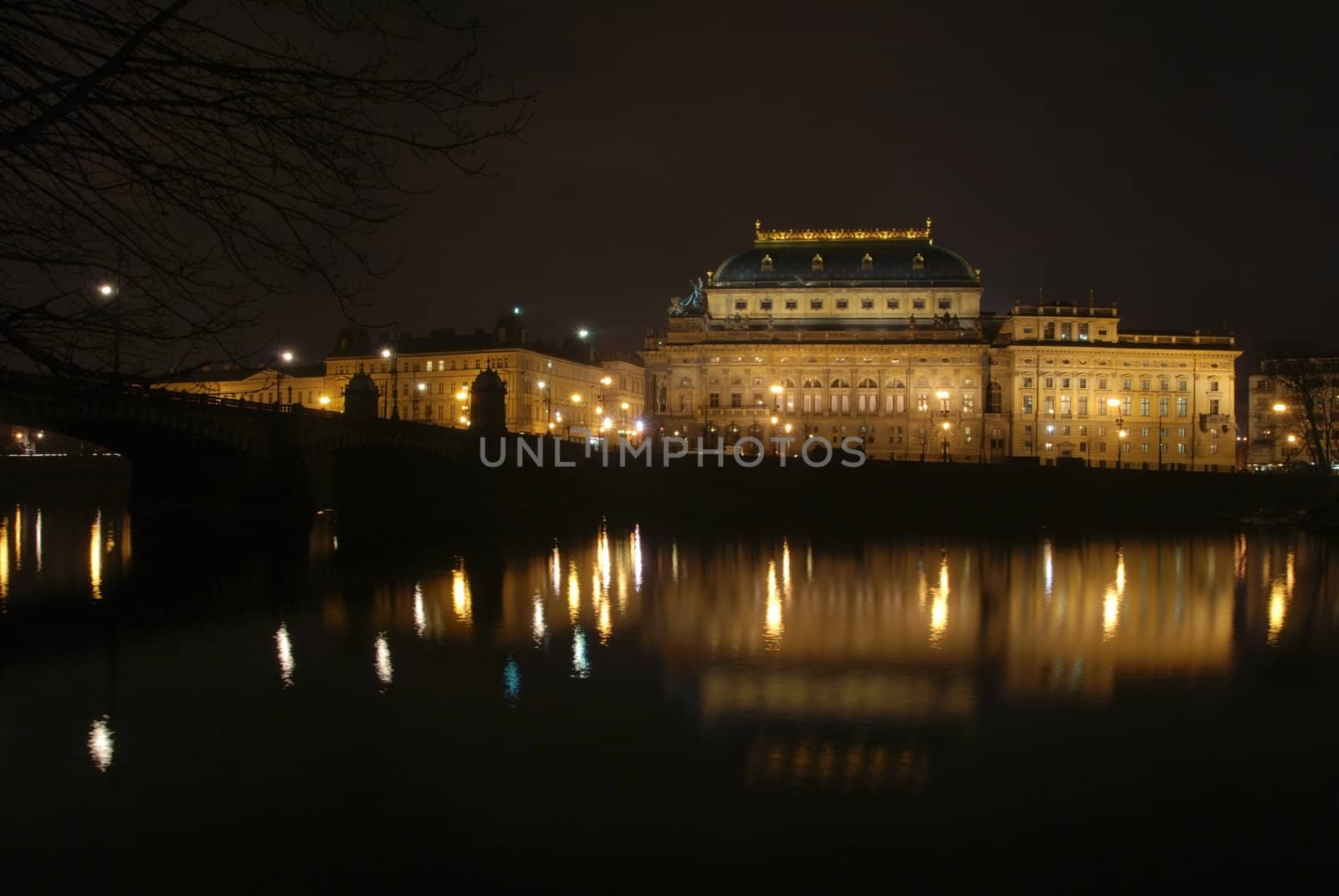 The Czech National Theater in Prague is reflecting after the dusk in the river Vltava