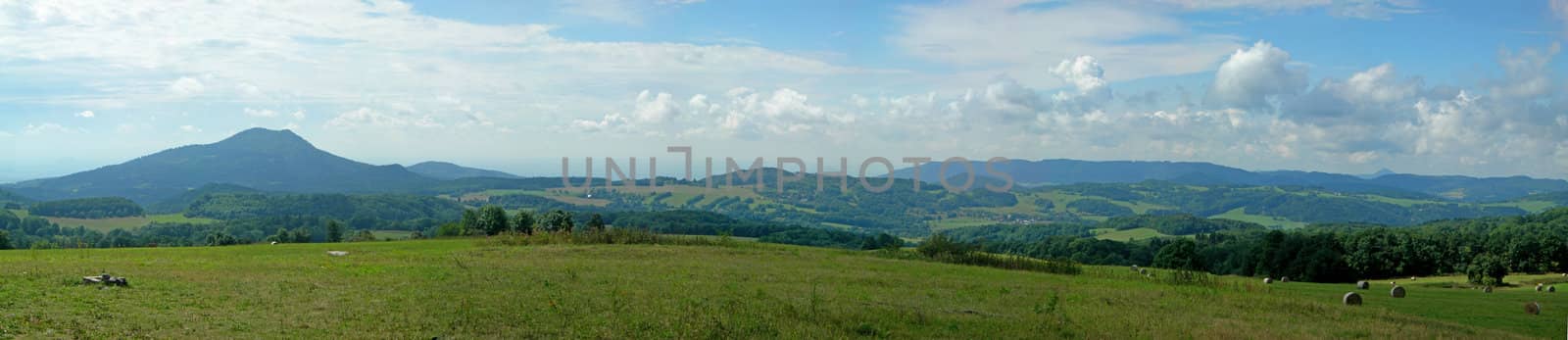 Landscape of a czech county - rural farms with hiils, pastures and fields