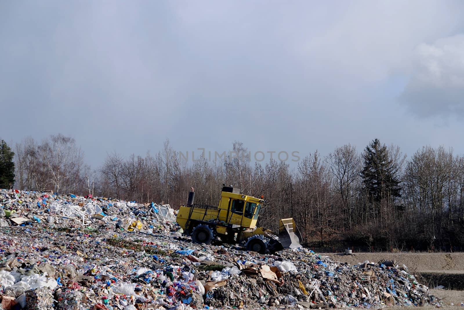 Bulldozer is processing waste in the dump