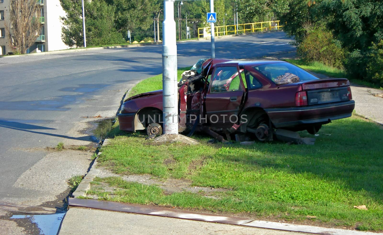   Red car after the terrible accident - it crashed into a pillar         