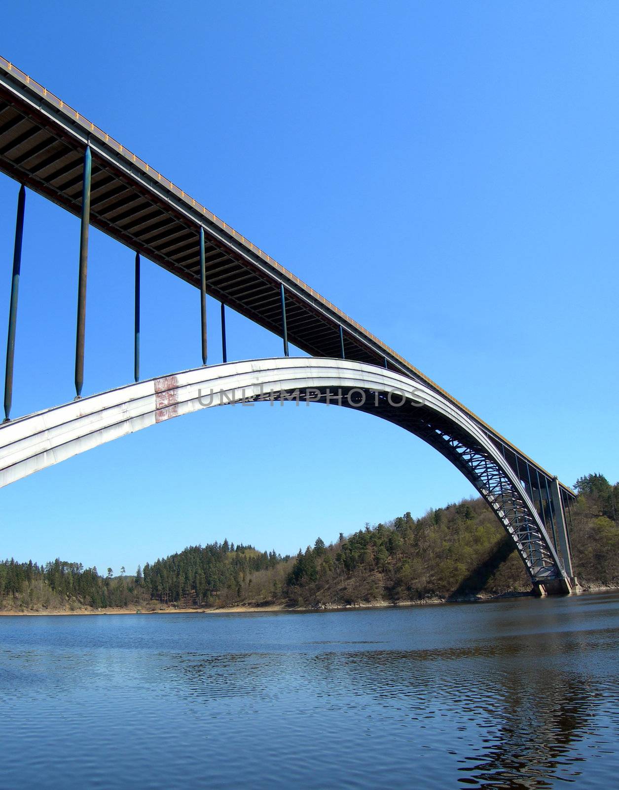 Bridge over the Vltava river. Massive steel construction with a long arch.